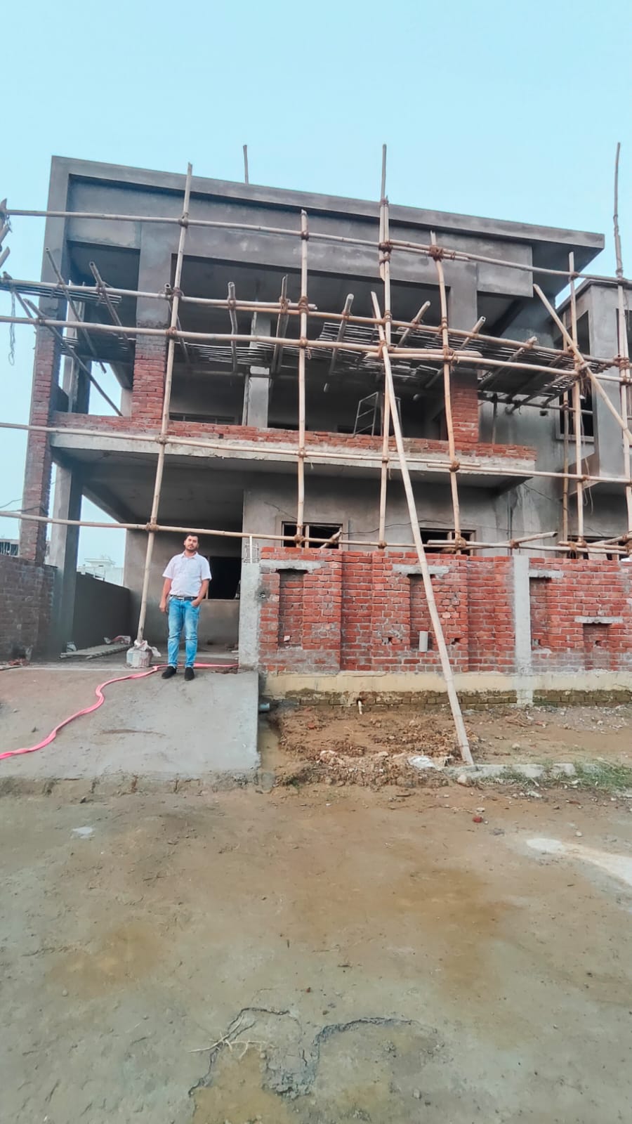 Construction site with person showing project scale and progress